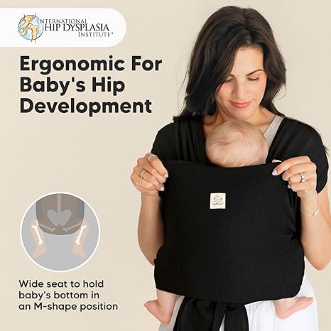 keaBabies D-Lite black baby wrap carrier with newborn infant positioned in ergonomic sling
