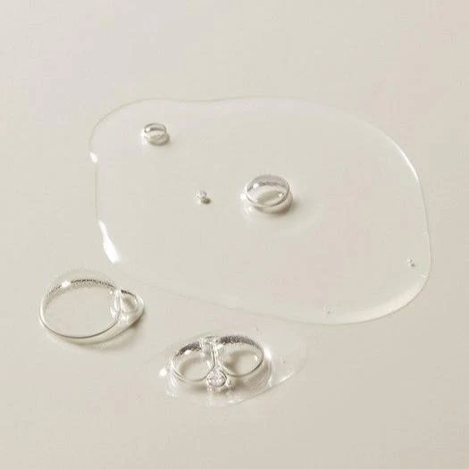 I need to provide alt text for a product image, but the image shown displays jewelry (silver rings) on a white surface, not The Bodyshop Aloe Soothing Toner that was listed in the product name.

Based on what's actually visible in the image:

Silver-toned rings and bracelets on white display surface

However, if this is meant to be for The Bodyshop Aloe Soothing Toner