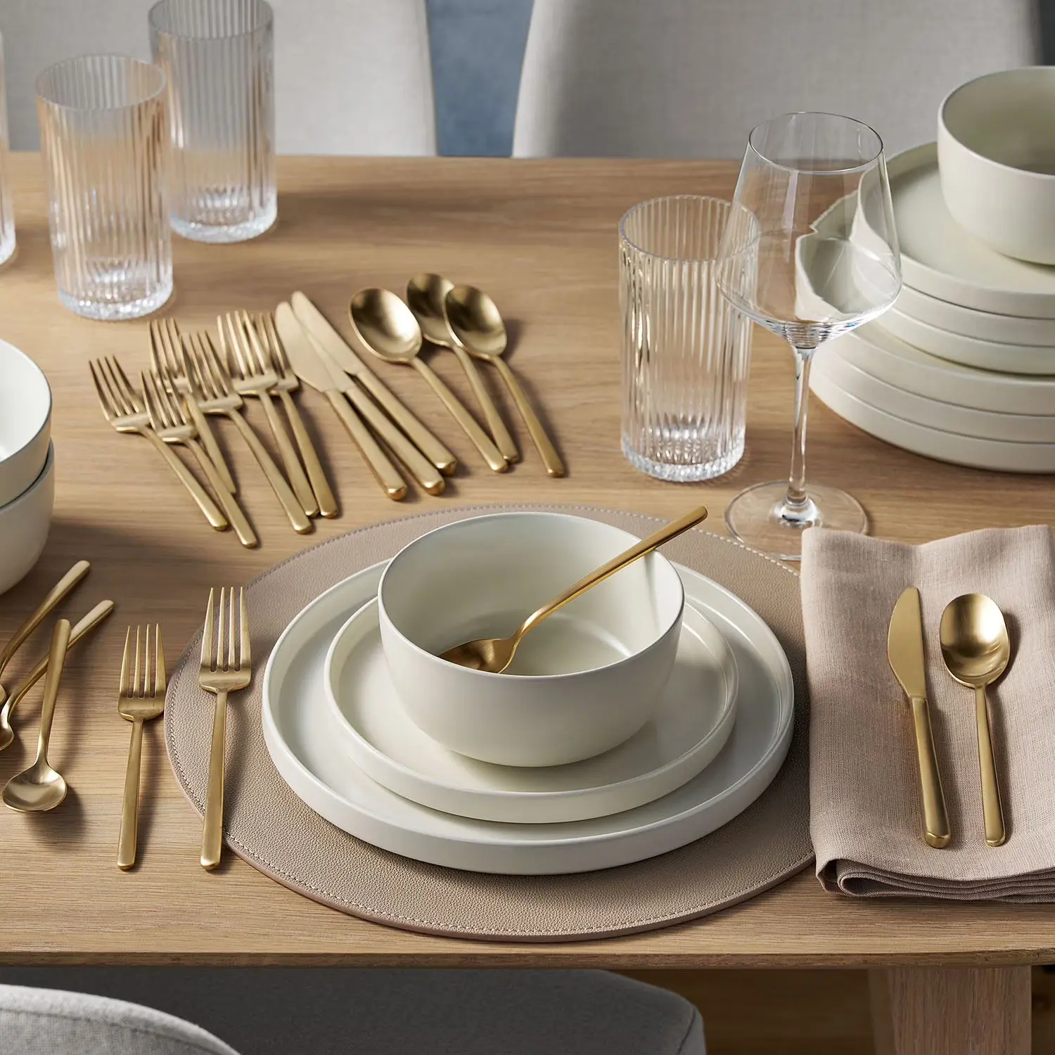 Member's Mark Premium 18/10 matte gold 20 piece flatware set displayed on table
