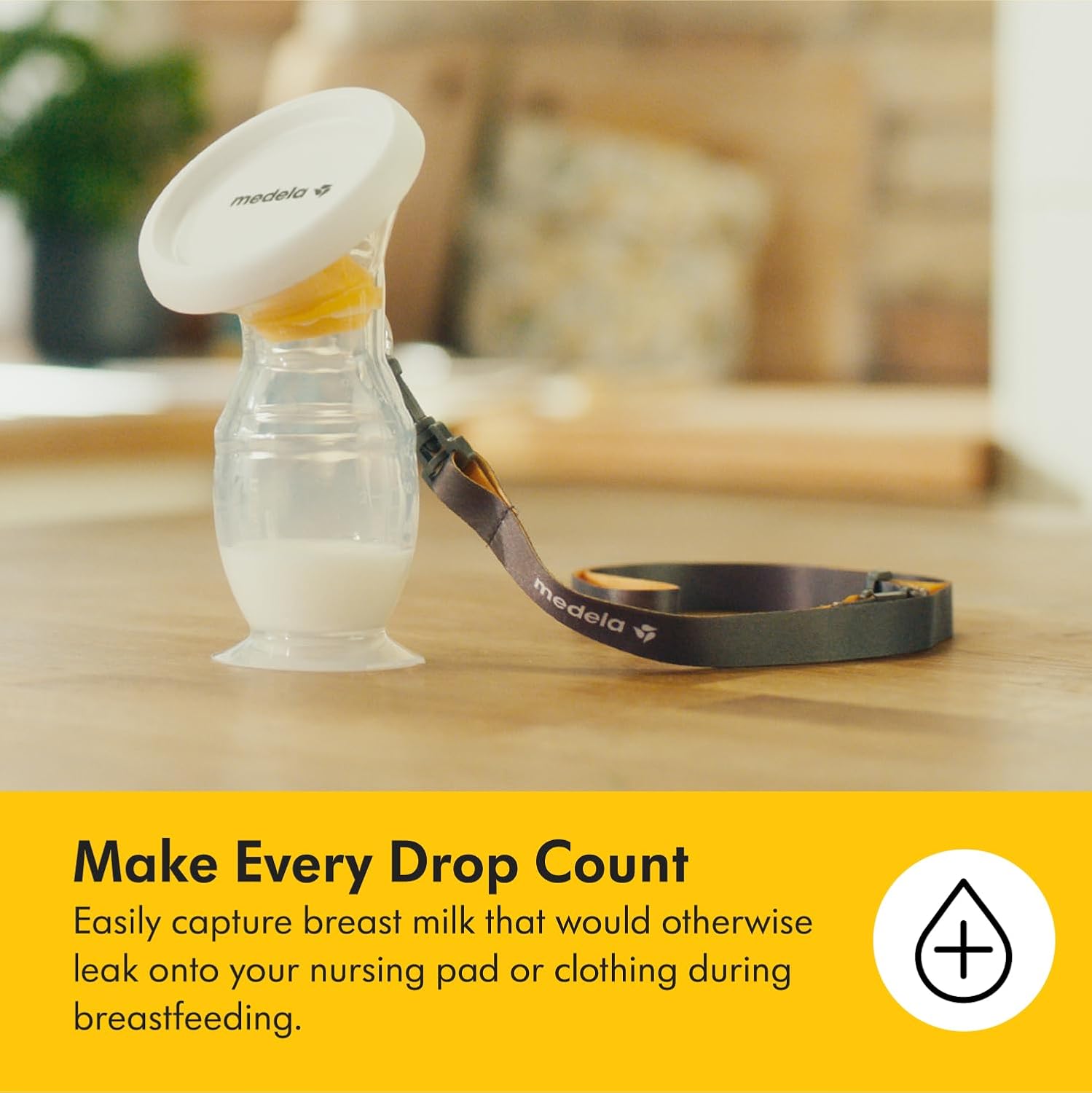 Medela silicone breast milk collector with white cap and collection bottle