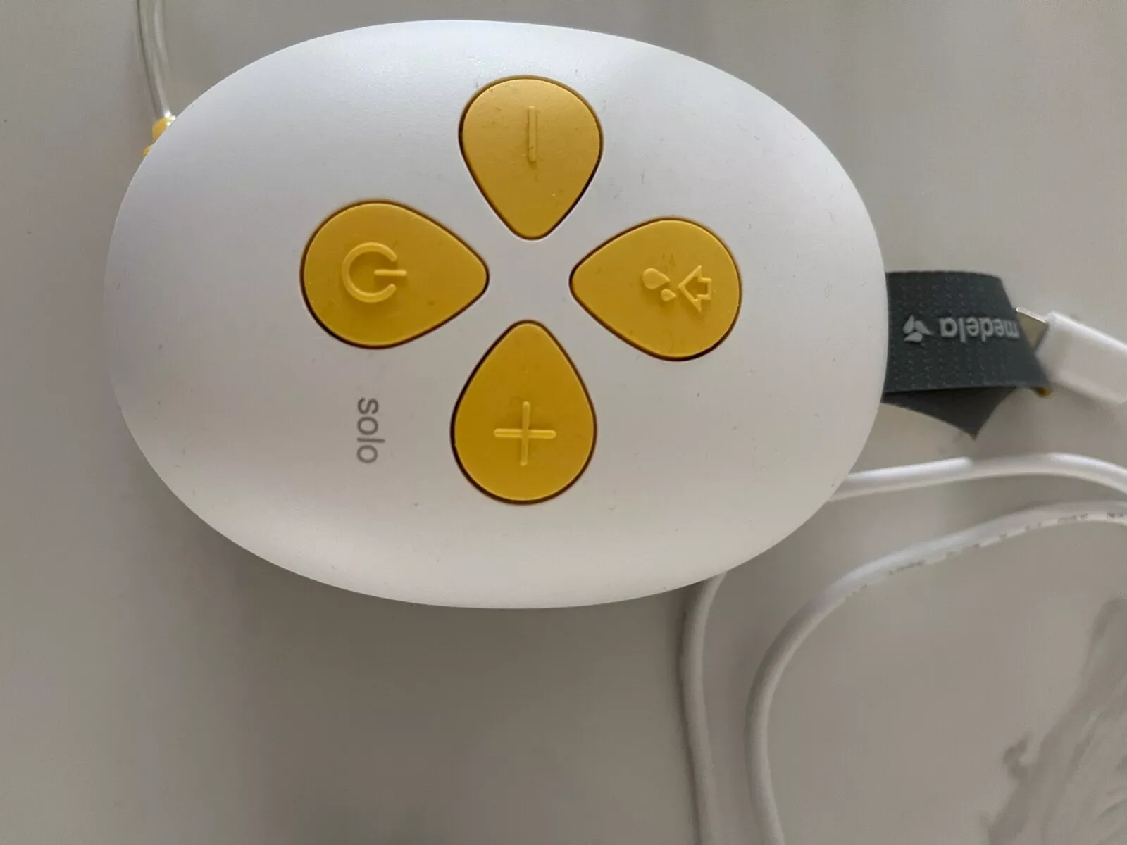 Medela Swing Flex single electric breast pump control panel with yellow buttons