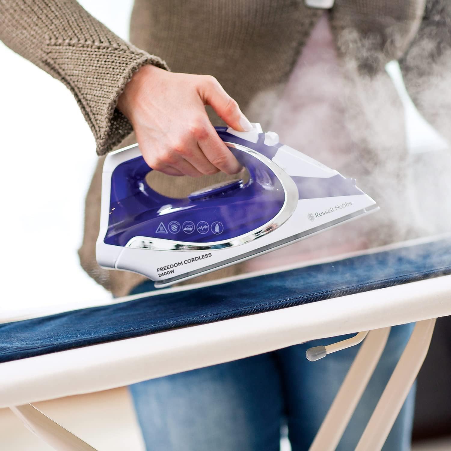 Russell Hobbs Freedom cordless steam iron purple and white being used on fabric
