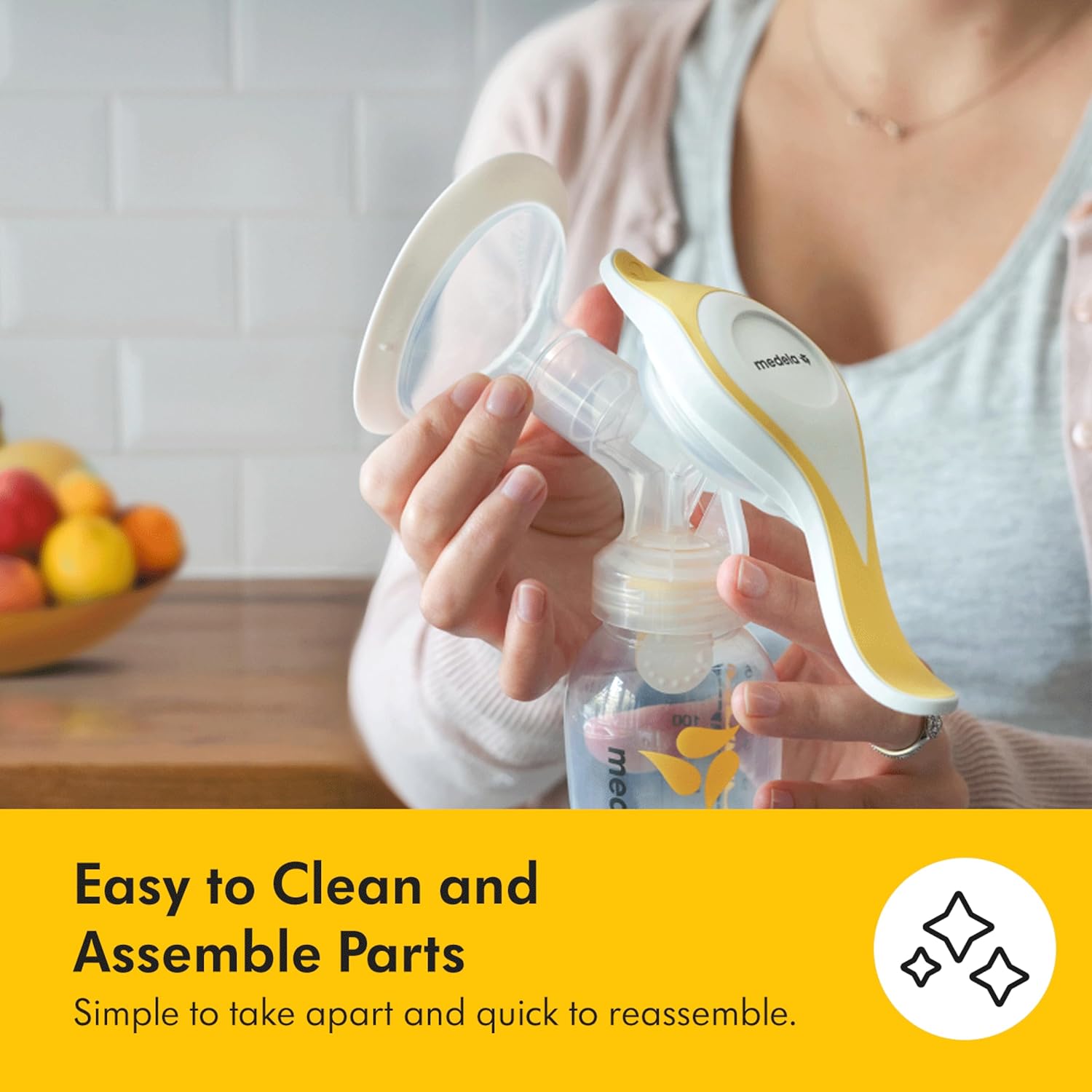 Medela Harmony Flex white and gold manual breast pump with collection bottle