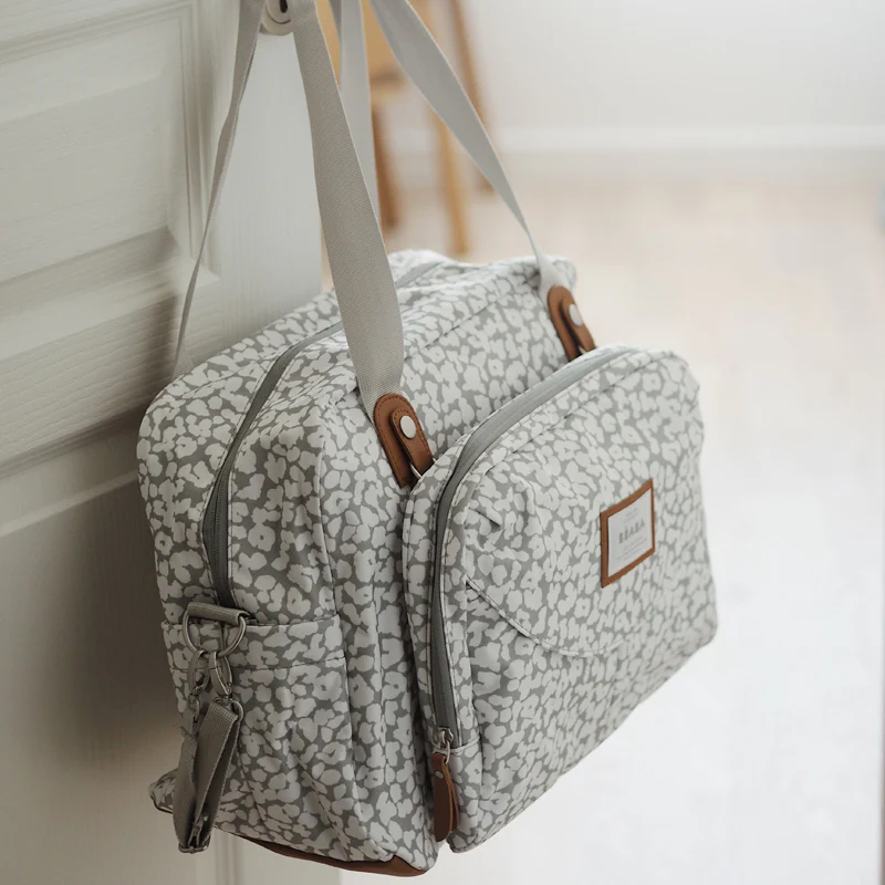 Béaba Geneva II changing bag 23L cherry blossom pattern grey and white