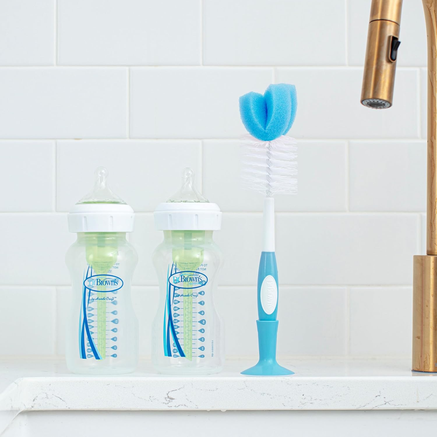 Dr. Brown's bottle brush with blue head and white bristles, suction cup base