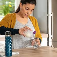 Nuk milk powder dispenser with blue polka dot design, portable feeding bottle holder