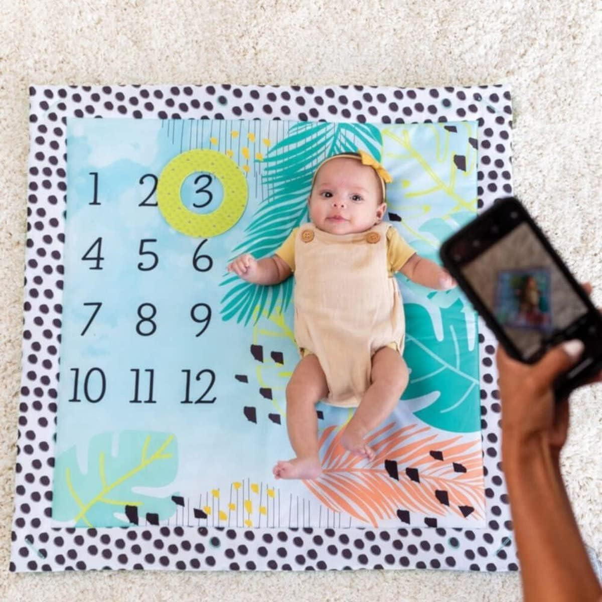 Infantino 4-in-1 Twist & Fold baby gym mat with milestones and memories design