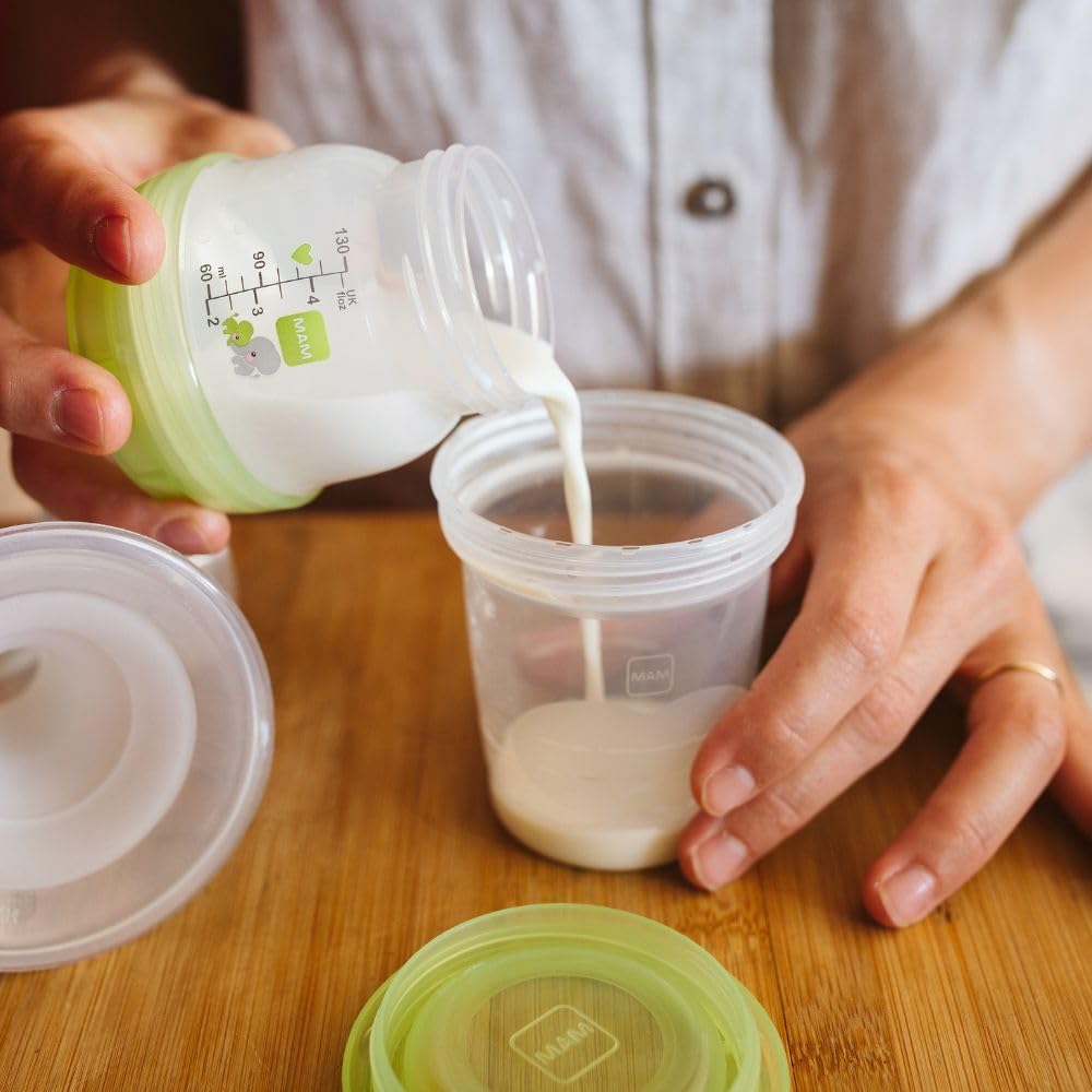 MAM Storage Pot with green lid and measurement markings, pouring milk