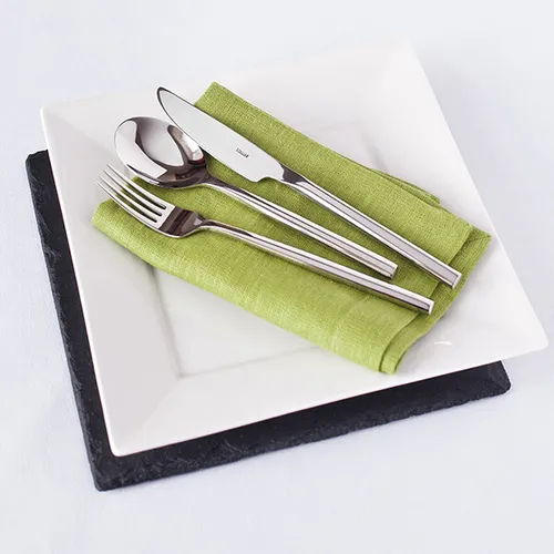 Stellar Rochester stainless steel table spoon with green napkin