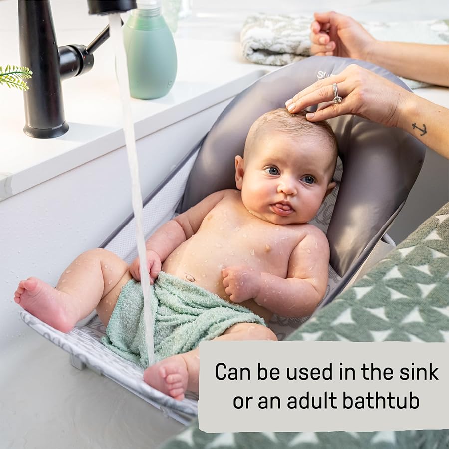 Ingenuity Summer Infant grey foldaway baby bath seat with newborn infant in sink