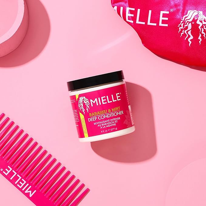 Mielle Babassu and Mint deep conditioner 227ml jar with black lid on pink background